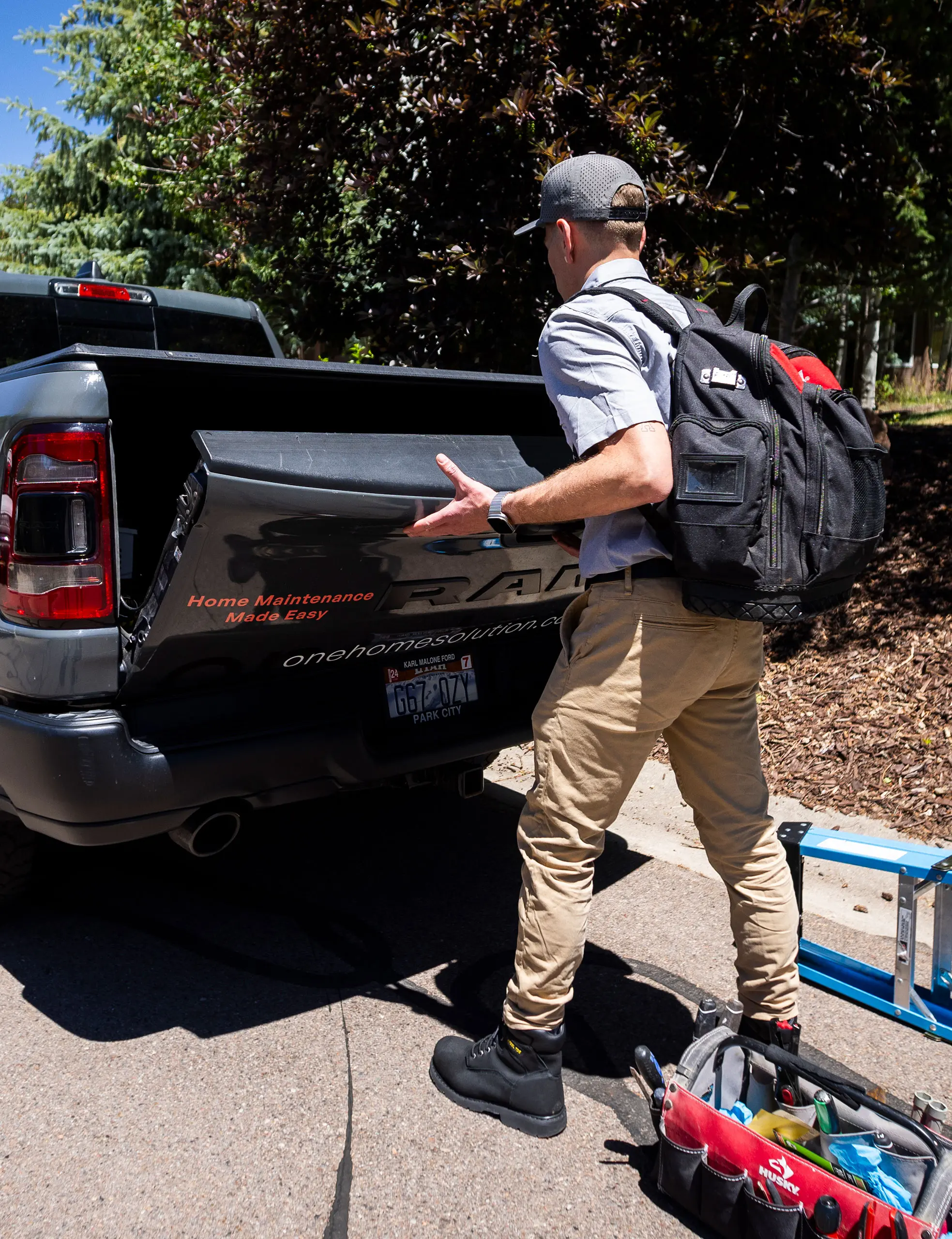 Man Closing a Pick Up Trunk