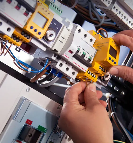 Licensed handyman installing a wall electrical outlet in a modern home interior