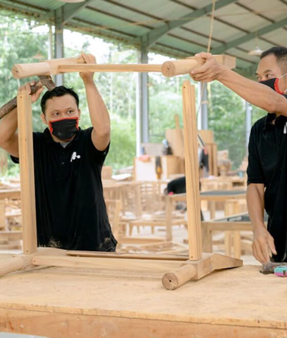 A handyman assembling flat pack furniture with tools in a modern living room