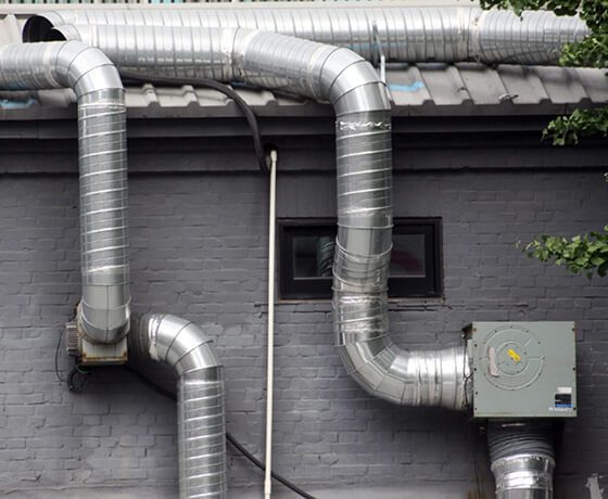 Technician using specialized tools to clean a residential dryer vent system